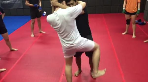 Muay Thai Singapore West students practicing Muay Thai kneeing techniques during clinching