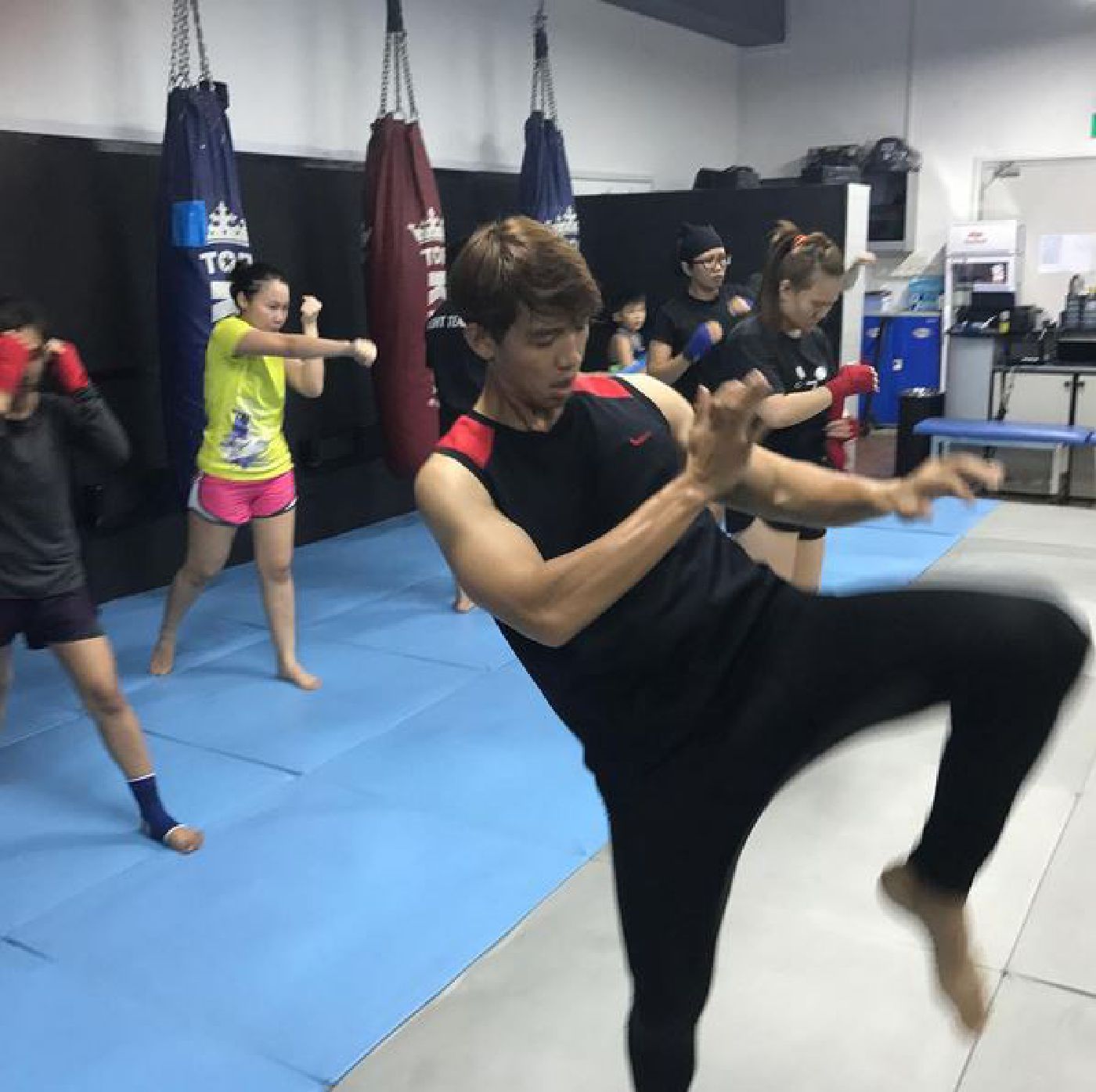 Muay Thai Singapore West students doing shadow boxing warm-up drills