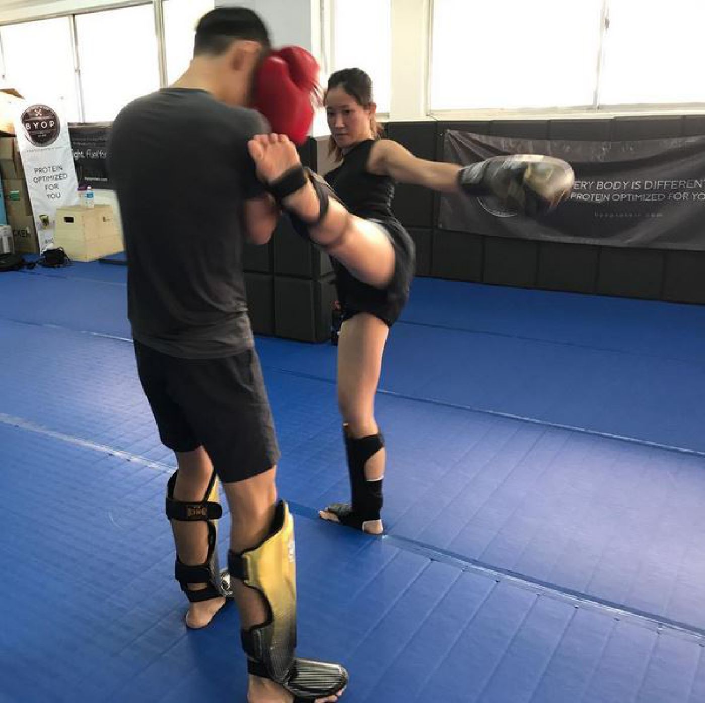 Muay Thai Singapore West students practicing their high kicks